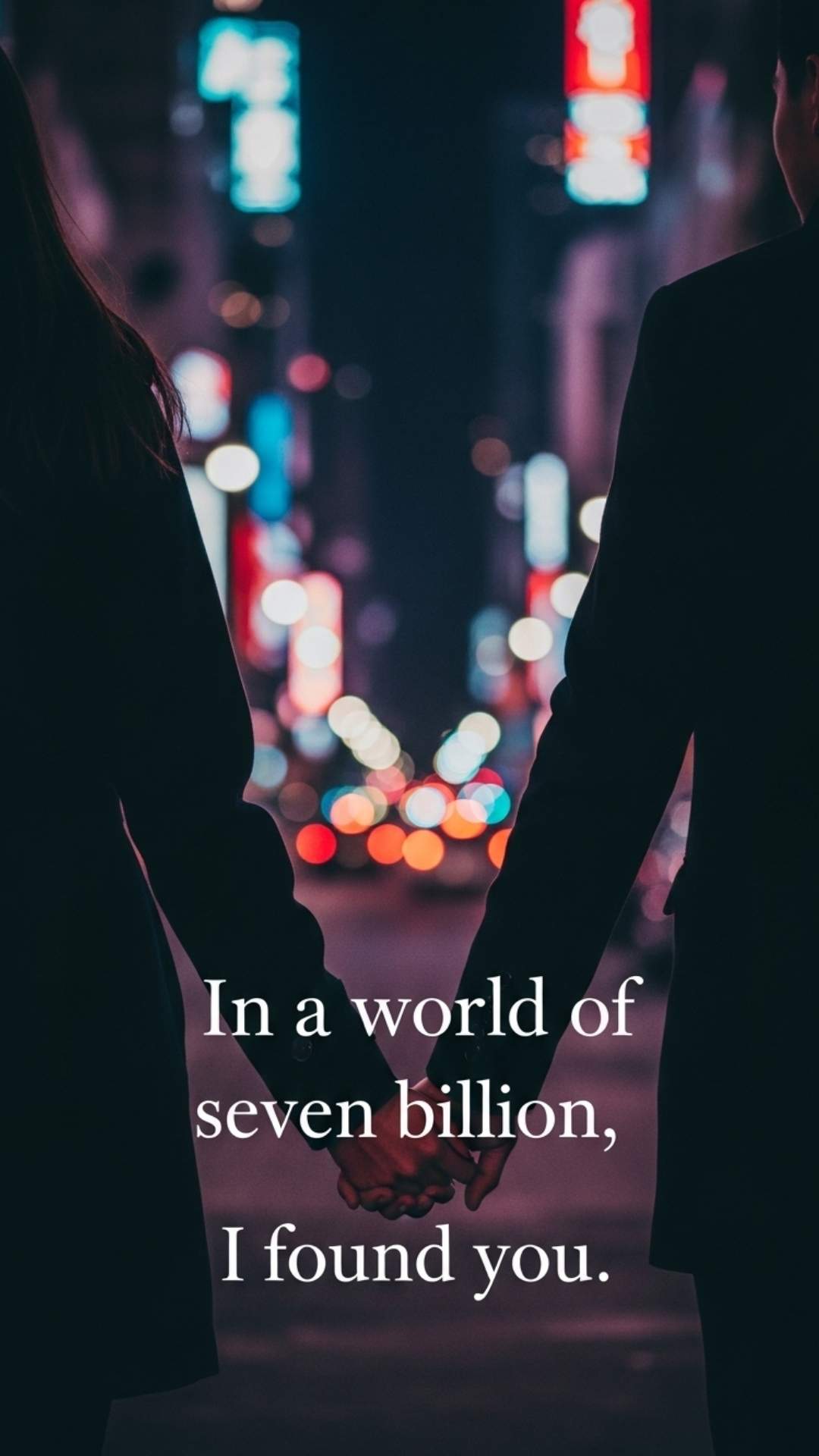 A couple holding hands while walking in a bustling city at night with a love quote