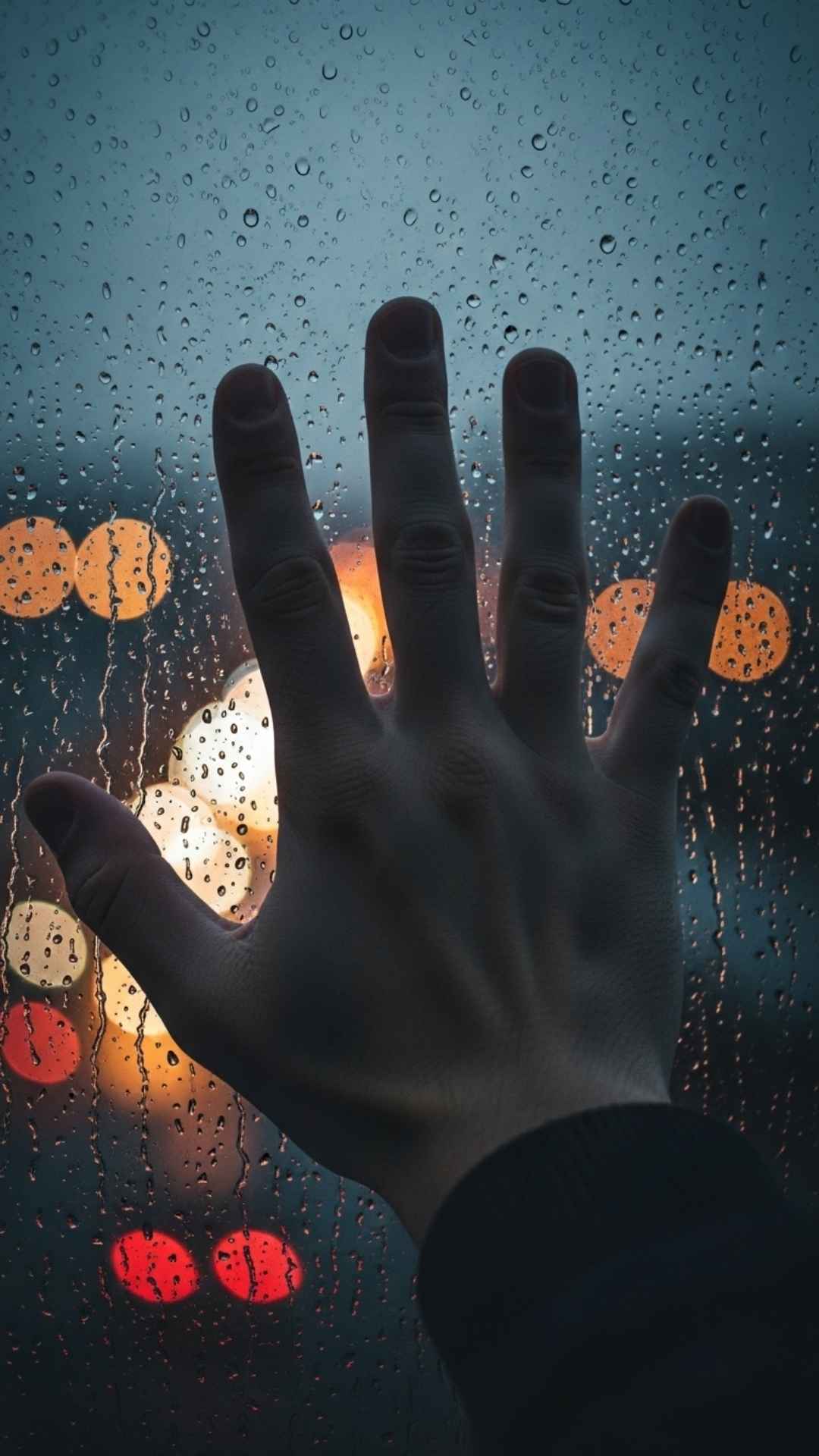 Sad DP showing a boy's hand on a rainy window, feeling lonely and reflective.
