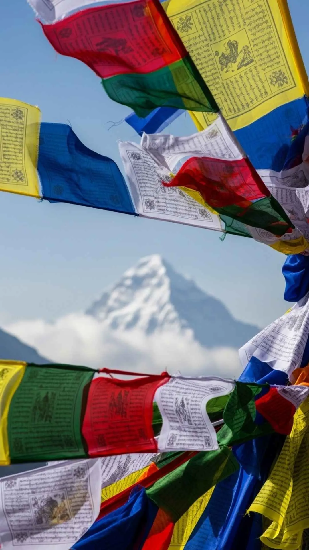 Colorful Tibetan prayer flags fluttering in the wind in the Himalayas. A spiritual and healing DP symbolizing peace, blessings, and positive energy