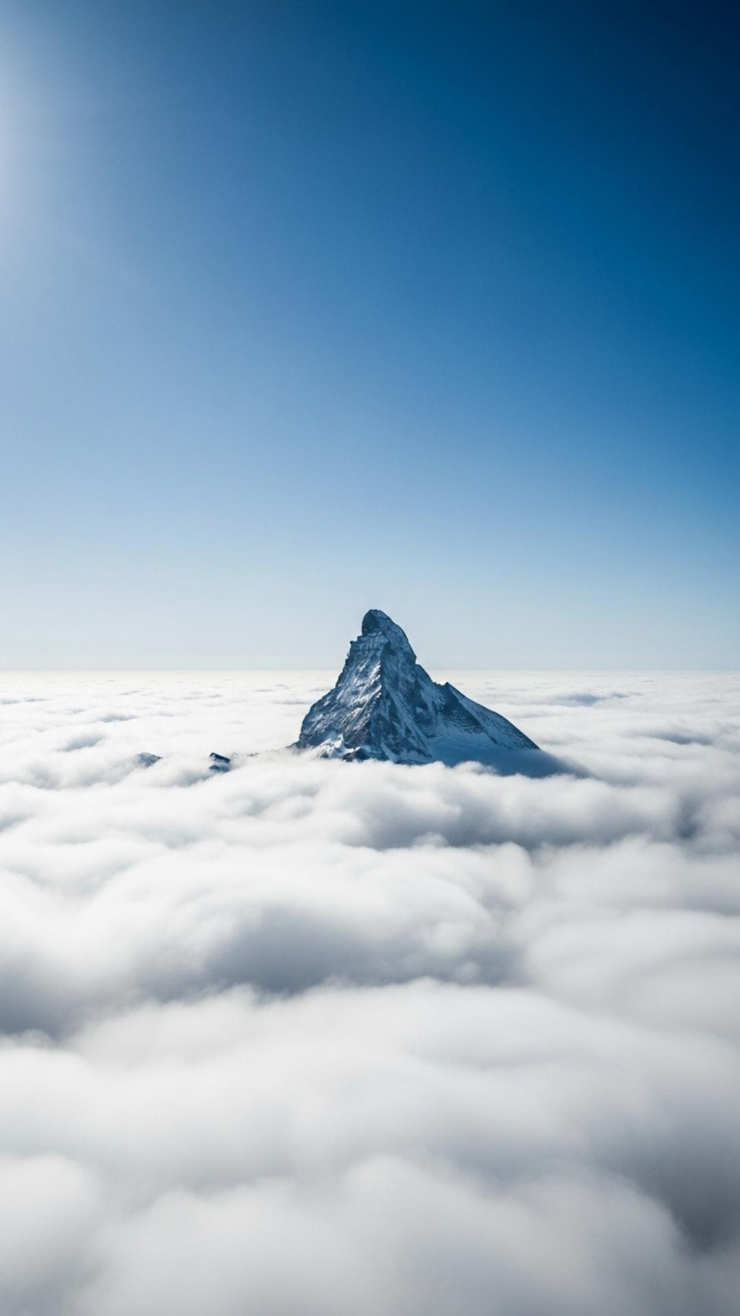 Nature DP for WhatsApp showing a mountain peak rising above a sea of clouds, symbolizing ambition, success, and reaching one's goals.