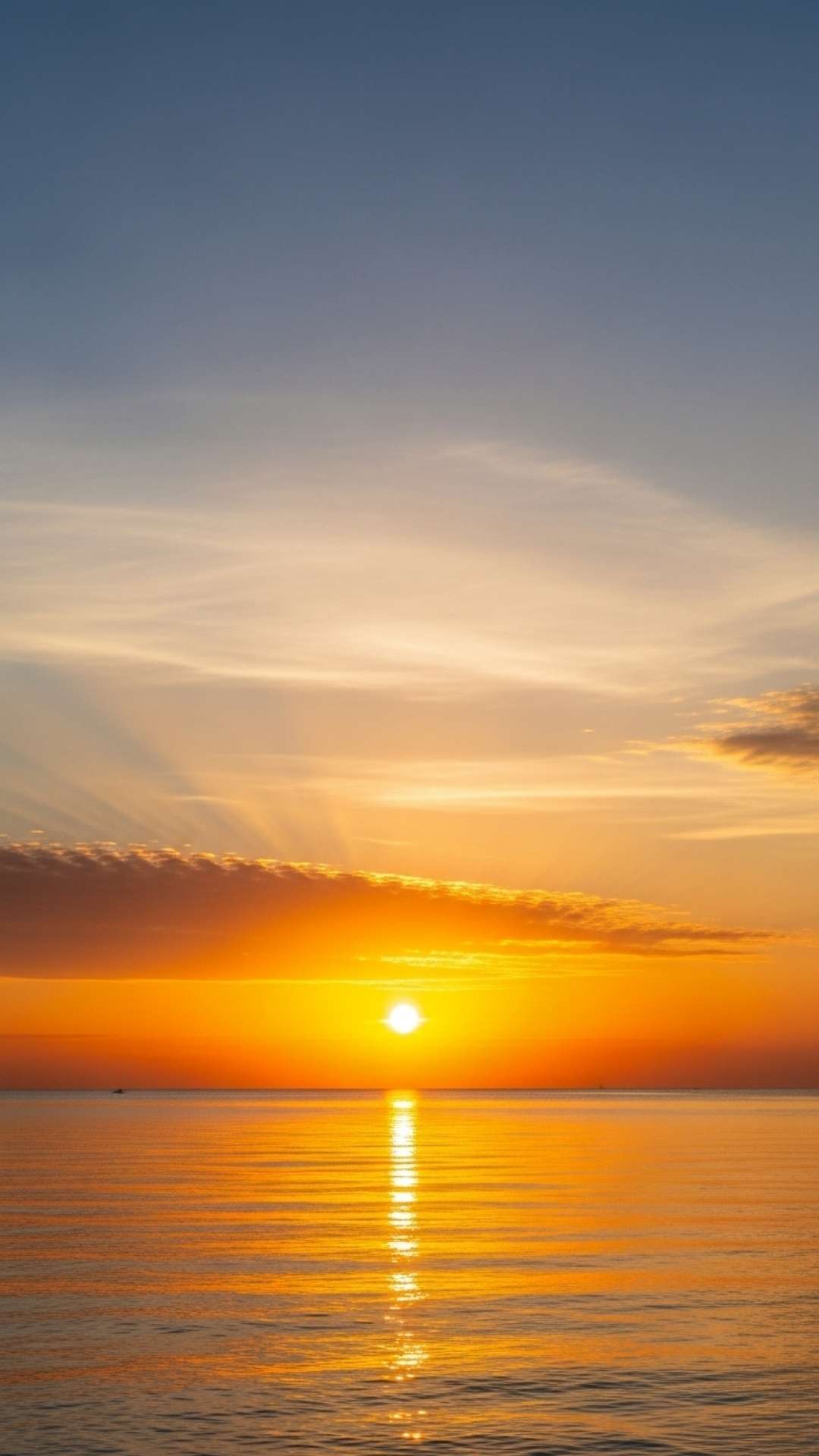 A stunning photo of a sunrise over a calm ocean, with a golden glow and soft clouds, symbolizing new beginnings and peacefulness.