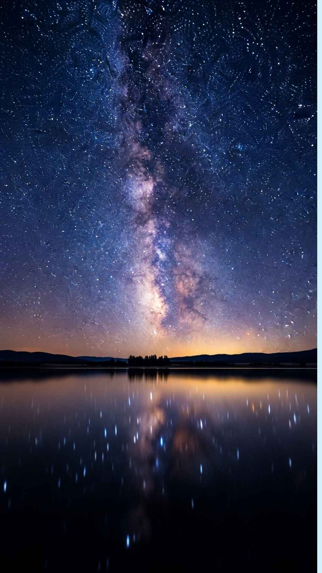 A high-definition photo of a star-filled night sky and the Milky Way reflecting in a tranquil lake, symbolizing peace and the vastness of the universe