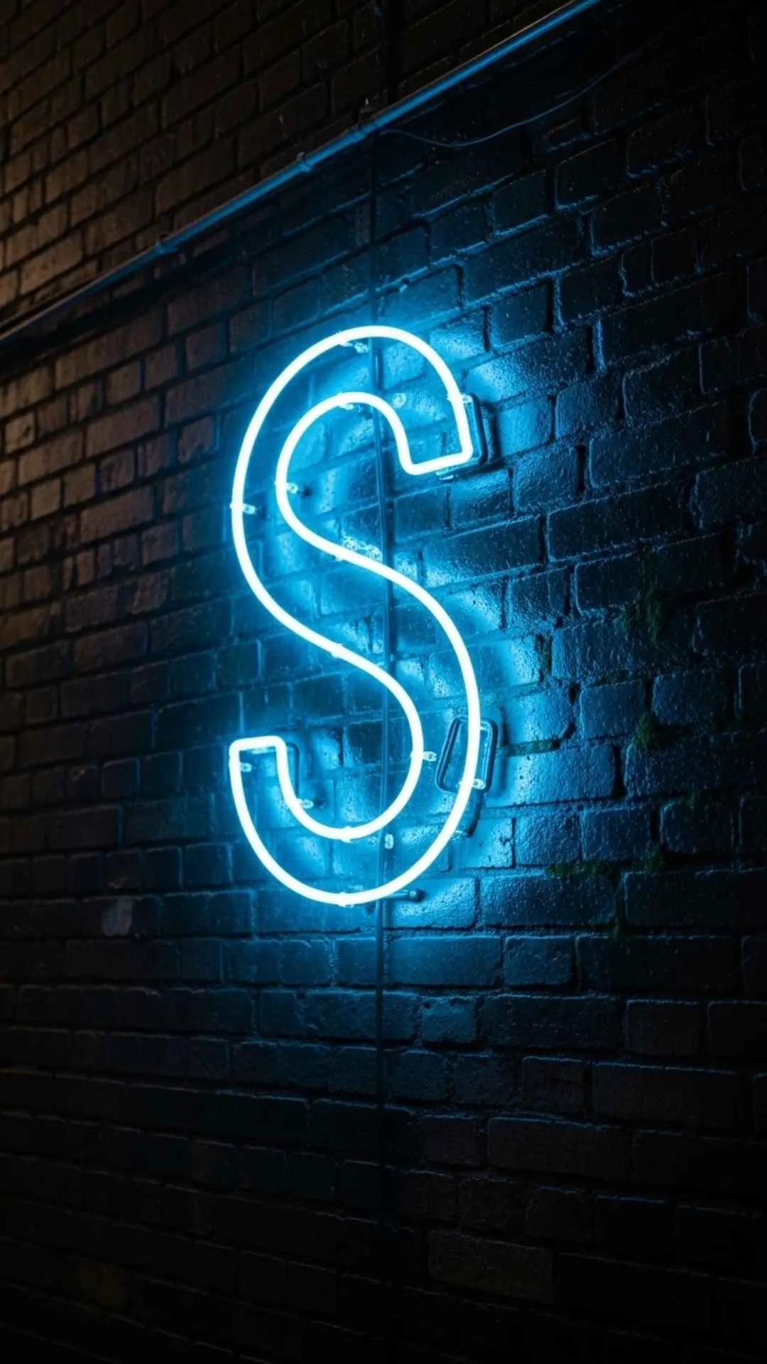A cool S letter DP for boys, featuring a vibrant electric blue neon 'S' glowing against a dark, wet brick wall. This stylish S name DP with attitude conveys an edgy, urban vibe, making it a perfect HD 4K profile picture for WhatsApp or Instagram in India