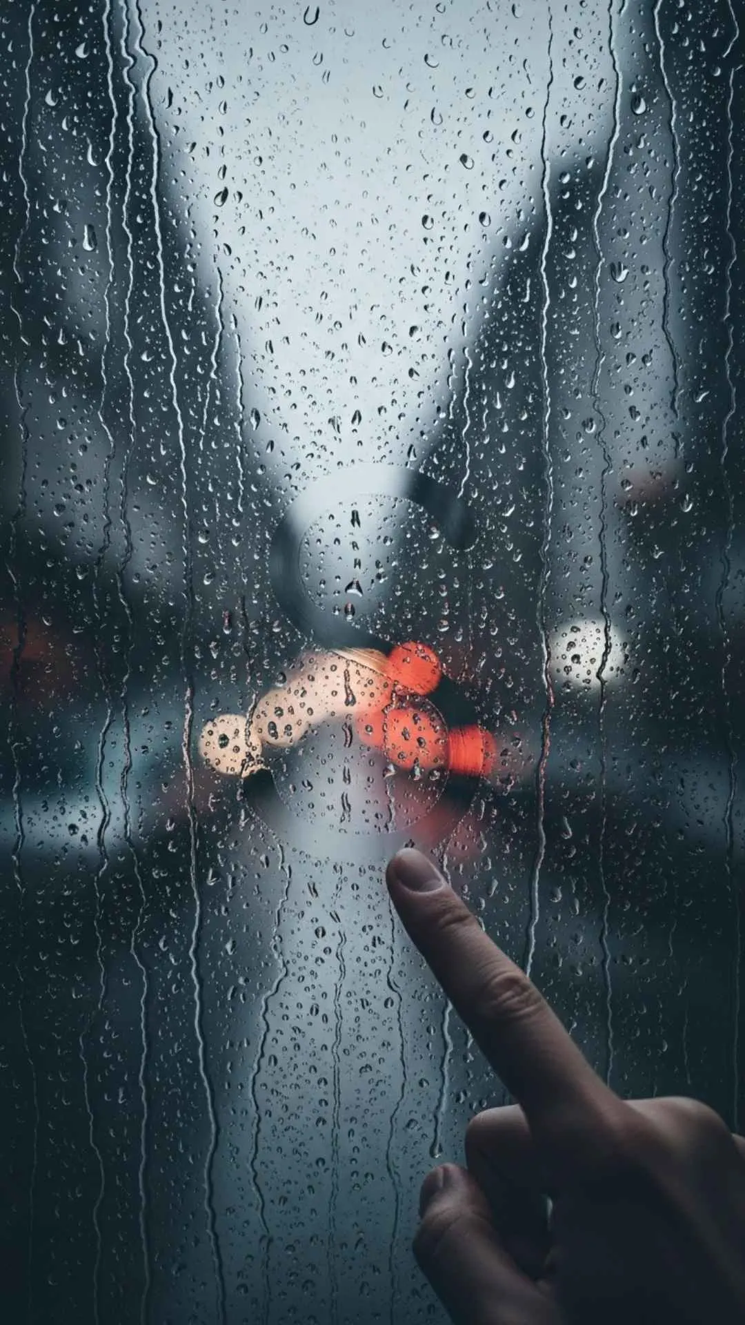 A very sad S letter DP, showing a rain-streaked window with the letter 'S' drawn on it, blurred by the rain. This aesthetic, moody S name DP for boys and girls in India perfectly captures a feeling of sadness and being alone. Free HD 4K download from Majekfilms.com