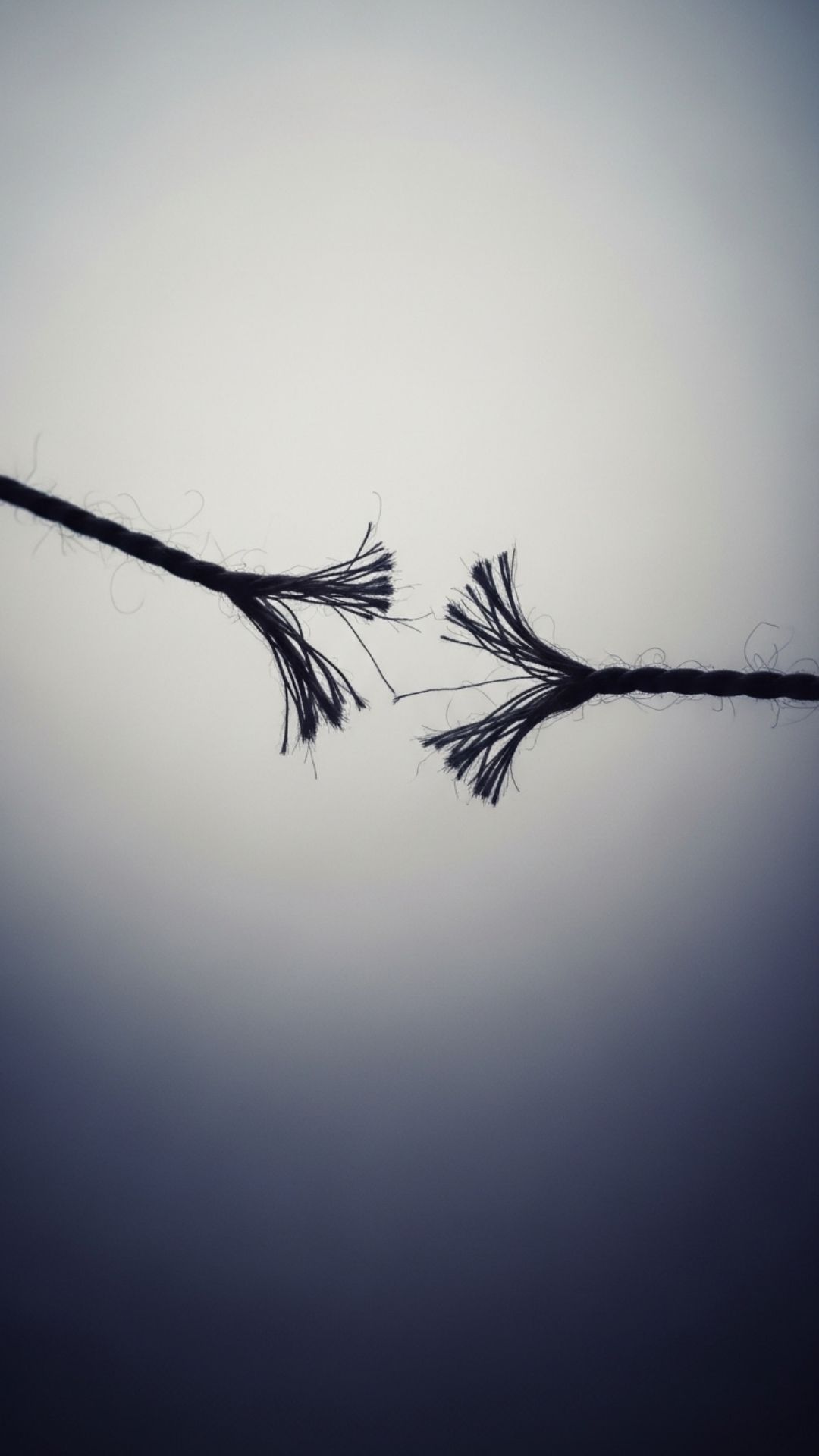 A sad Friendship DP showing a broken, frayed string, symbolizing a painful breakup or misunderstanding in friendship and feelings of loss.