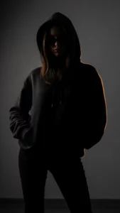 A stylish 4K "Attitude DP for girls" showing a cool silhouette of a girl in a hoodie, her face hidden to create mystery. This "No DP Image" is a perfect "hidden face" DP for an Instagram or WhatsApp profile.