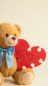 A cute teddy bear wearing a blue bowtie holding the left half of a red heart, designed as a matching couple DP for boys to pair with the girl's version on WhatsApp or Instagram.