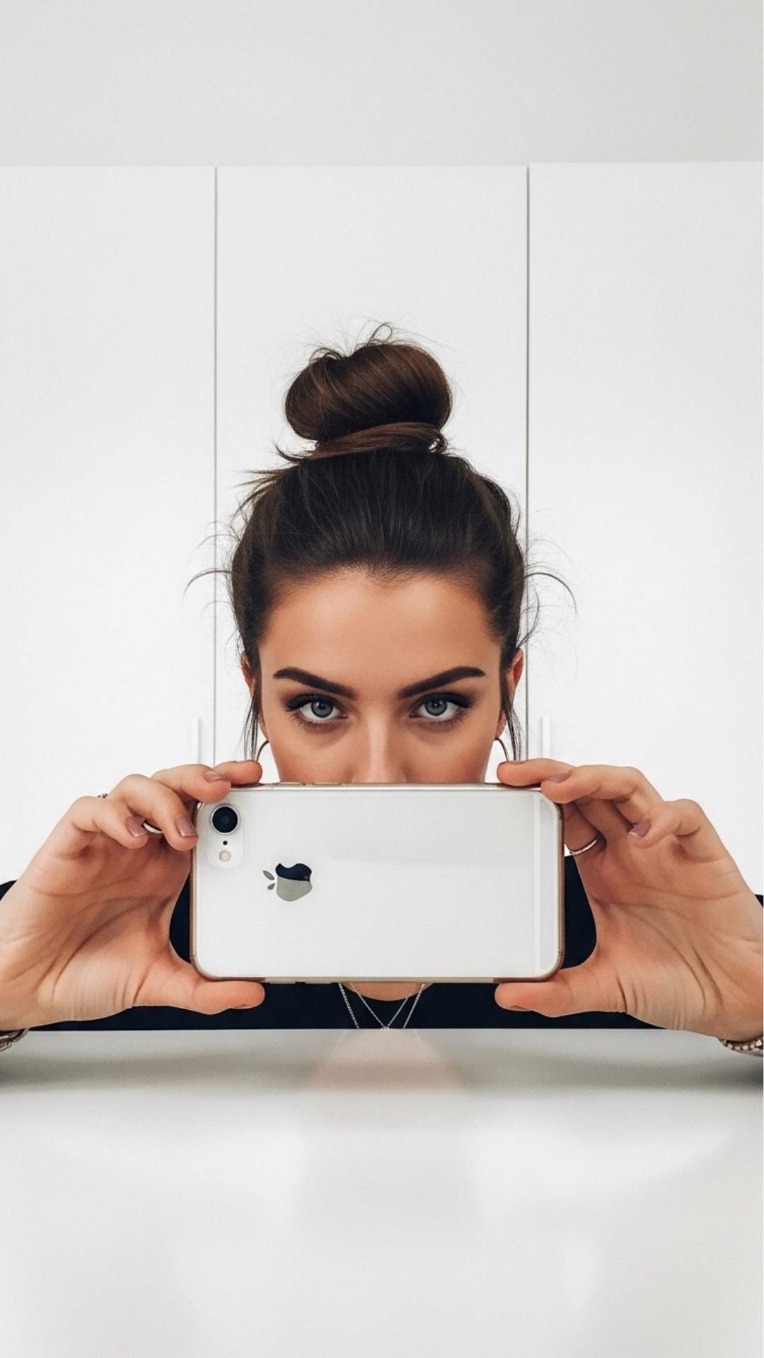 An "it-girl" aesthetic mirror selfie using the "phone-down" technique to cover the bottom half of the face. This cute DP idea focuses on the eyes and hairstyle while adding an edgy, mysterious touch, popular for girls' profiles on social media platforms like Pinterest.