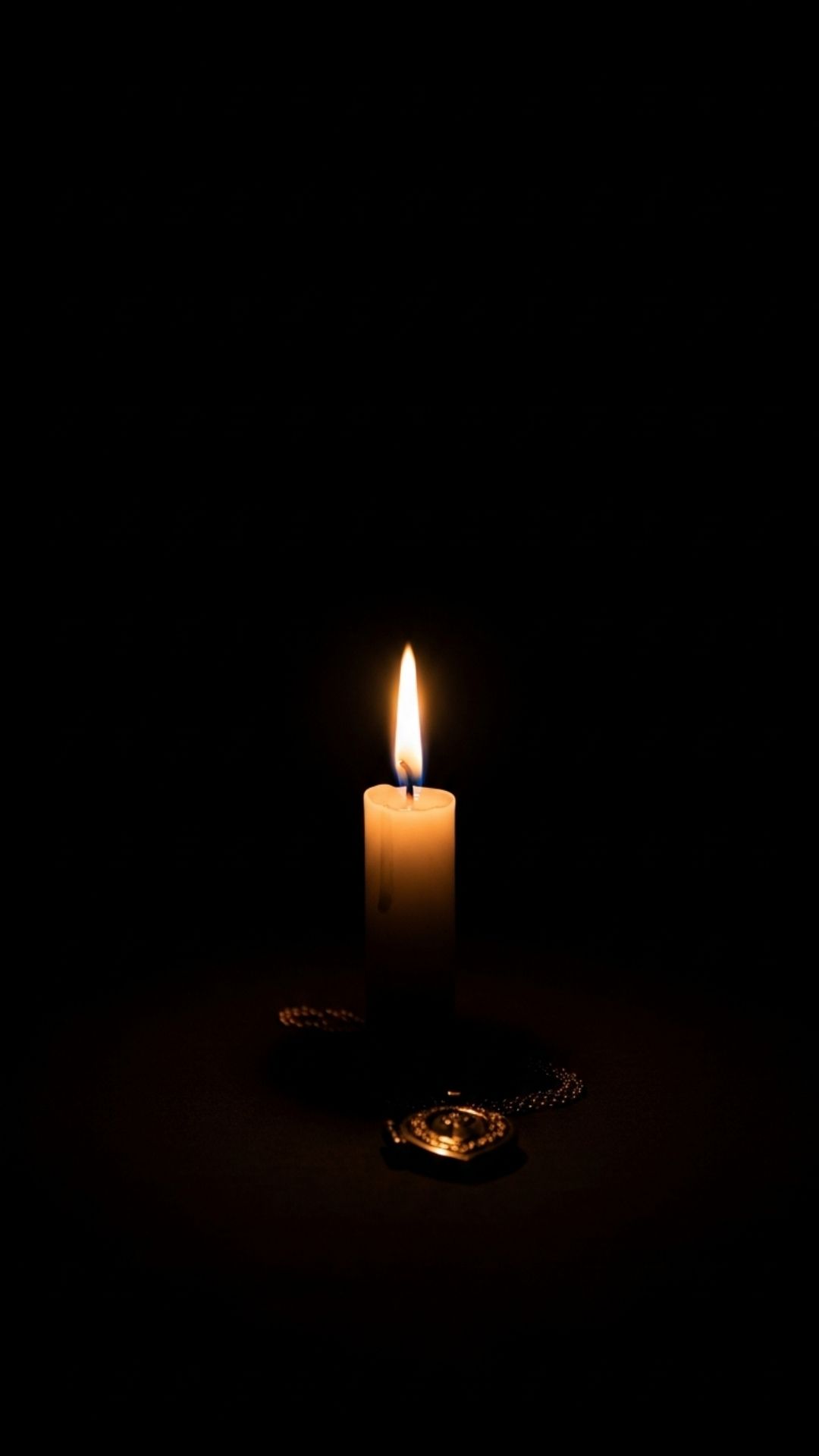 A vertical tribute image featuring a single burning candle in the dark, serving as a respectful RIP display picture or a symbol of remembrance and prayer for a departed family member on anniversaries.
